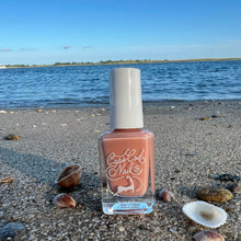 Load image into Gallery viewer, Nail polish bottle on a beach with ocean in the background